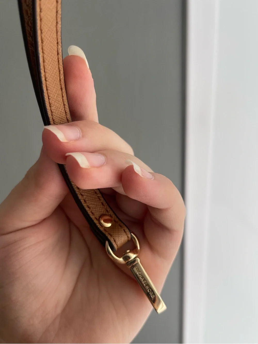 Brown Michael Kors wristlet strap